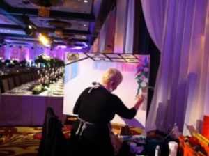 wedding artist painting picture of reception