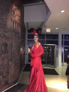 wedding entertainer with formal red dress and head piece as a wedding entertainment idea