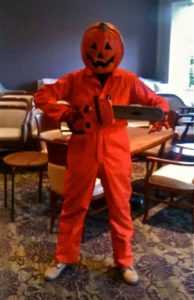 halloween event entertainer with pumpkin head and orange suit