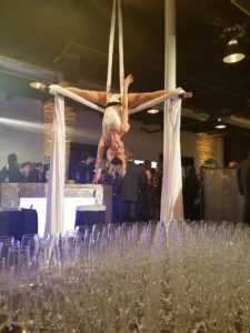 aerialist at event hanging from ceiling