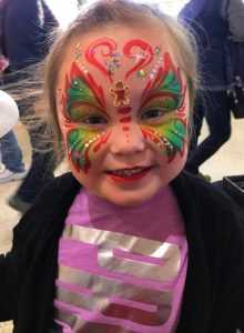 child with holiday facepaint for corporate christmas holiday party