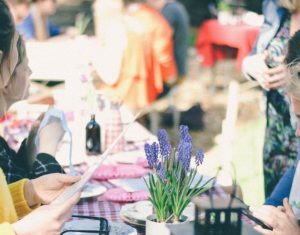 employees enjoying company picnic on checkered tablecloths