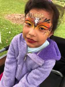 child with face paint at birthday party