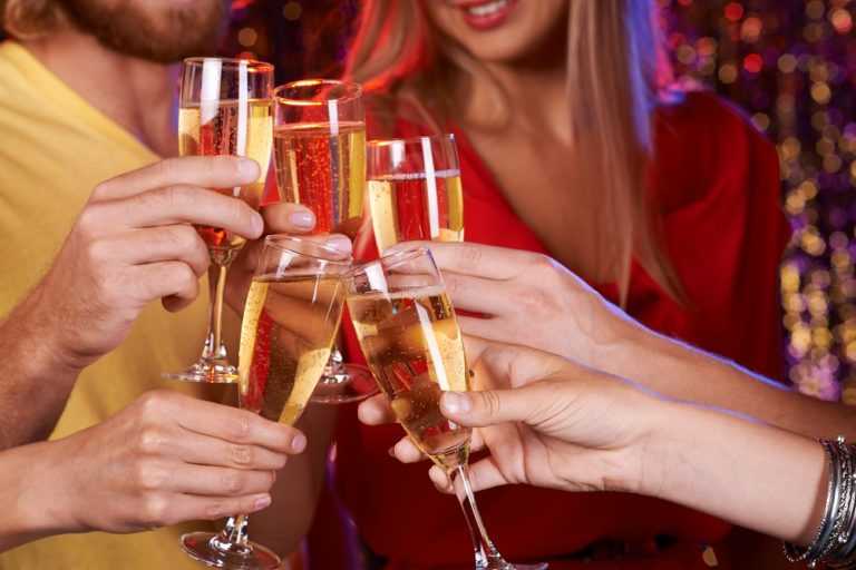 hands toasting champagne at a corporate holiday party venue